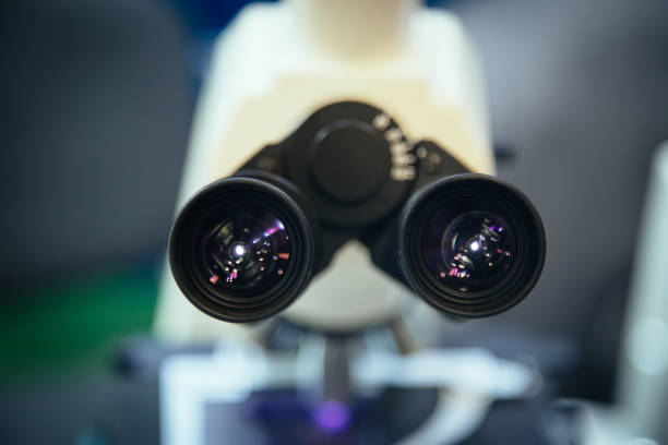 Ocular eyepiece lenses of binocular microscope, close up, selective focus.