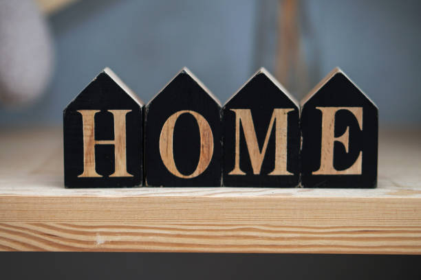 Inscription of small black cubes. Home is like a dream and a goal of life. Family comfort. stock photo