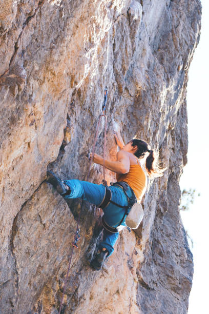 istock Woman climbs a rock. 1181089732