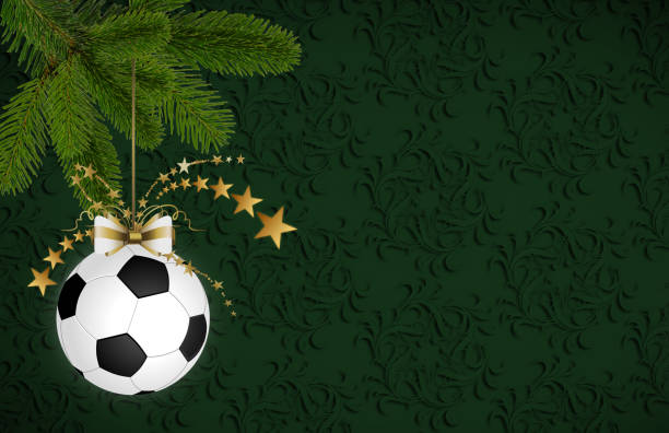 Soccer christmas bauble hanging on the fir branch. Christmas card with space for text stock photo