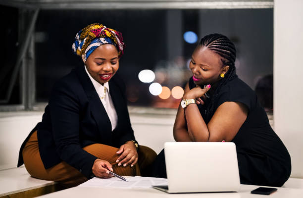 Analyzing  some documents Shot of two business women discussing over some contract document in office african stock pictures, royalty-free photos & images