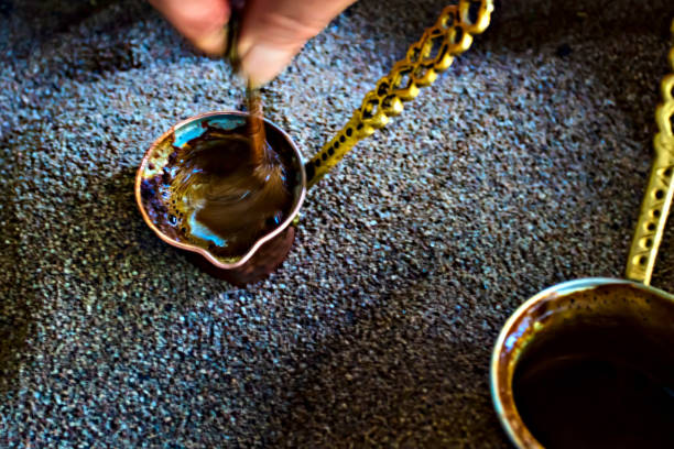 Traditional turkish coffee. It is cooking in hot sand.
