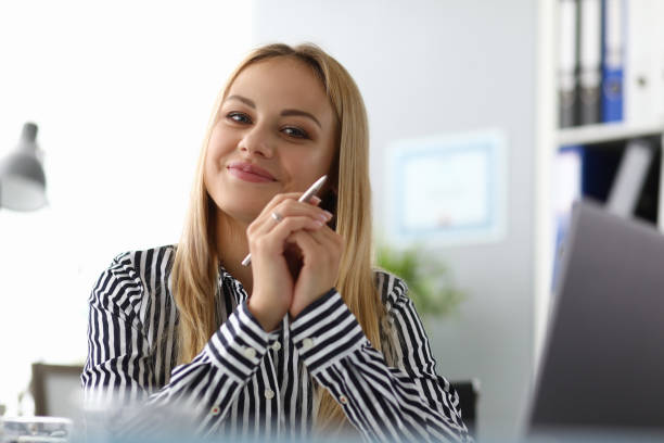 istock Cheerful beautiful woman posing in office 1181099350