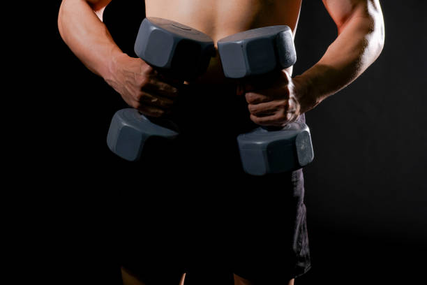istock athletic muscular bodybuilder man with naked torso six pack abs working out with dumbbell. fitness  exercise concept 1181099619