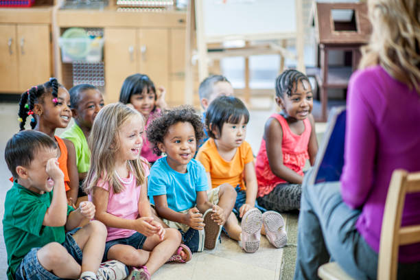 Groups of kids in preschool stock photo Multi-ethnic group of preschool kids playing and learning indoors. child care photos stock pictures, royalty-free photos & images