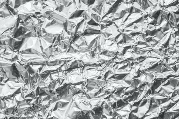 istock Shiny metal silver gray foil crumpled texture background 1181099797