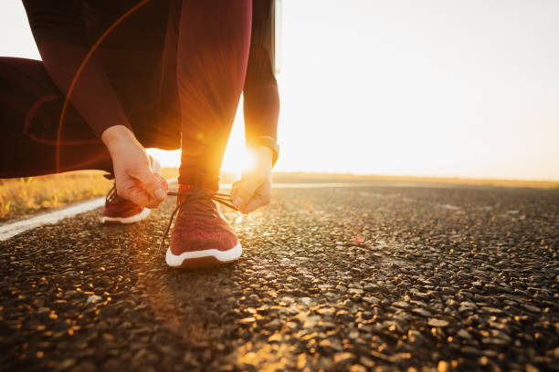 istock Sport runner woman tying laces before training. Marathon. 1181102226