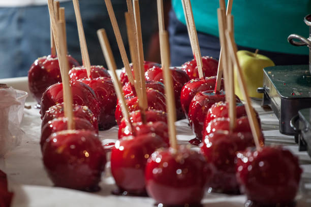 istock Candy Apples presented in rows in a fair, at night, with their typical red color. Also called Toffee Apples, these are traditional sweet treats from festivals, carnivals and outdoor parties 1181104021