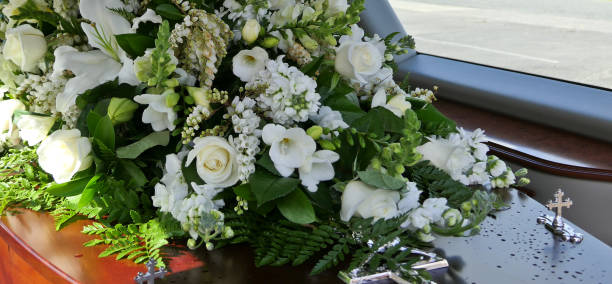 closeup shot of a funeral casket in a hearse or chapel or burial at cemetery closeup shot of a funeral casket in a hearse or chapel or burial at cemetery hearse photos stock pictures, royalty-free photos & images