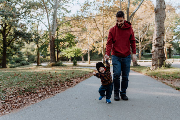 istock father and son walking in new york 1181108130
