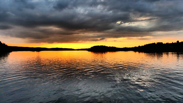 istock Sunset on the horizon on the river under a cloudy sky 1181108215