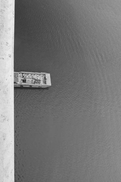 Boats on the Loire river. Gennes-Val-de-Loire, Loira, Loire, Maine-et-Loire. France. Black and white.