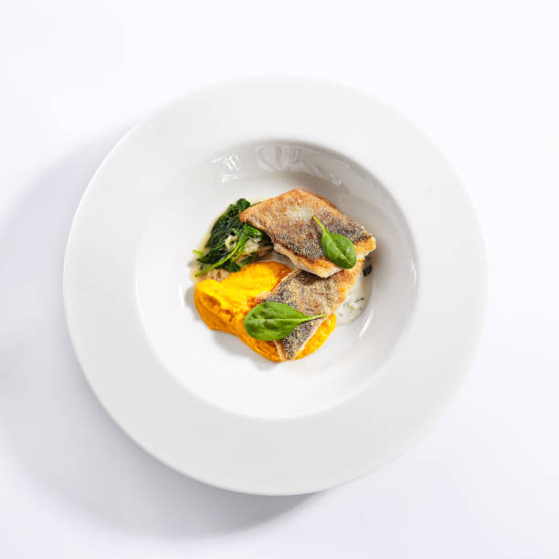 istock Cod fillet with pumpkin puree and spinach top view 1181119222