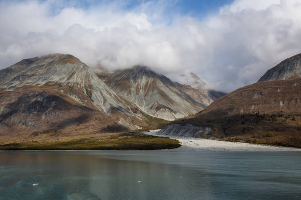 Beautiful View of a Glacier in the American Mountain Landscape on the Ocean Coast during a cloudy morning in fall season. Taken in Glacier Bay National Park and Preserve, Alaska, USA.