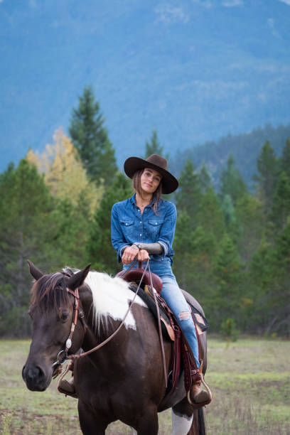 istock Cowgirl riding her horse 1181123355