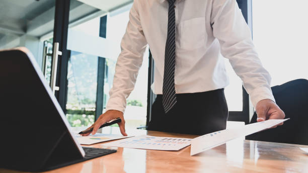 istock Cropped shot businessman analysis and contemplate discussion or compare paper work. 1181124897