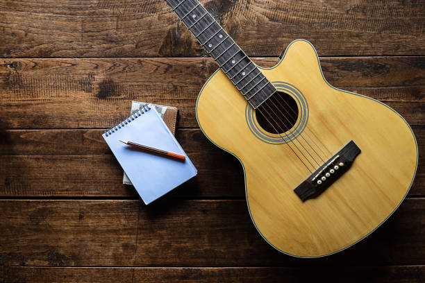 istock Classical guitar on wooden background 1181125647