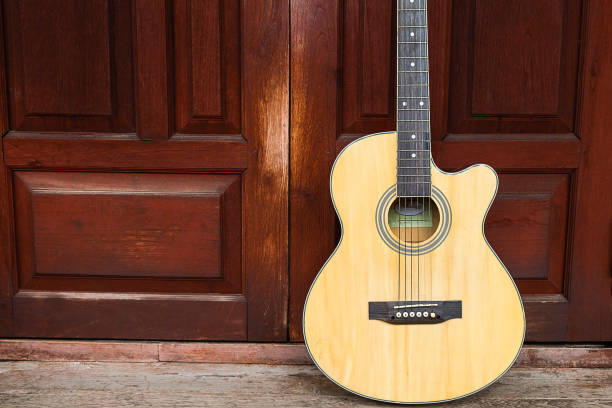istock Classical guitar on wooden background 1181125672