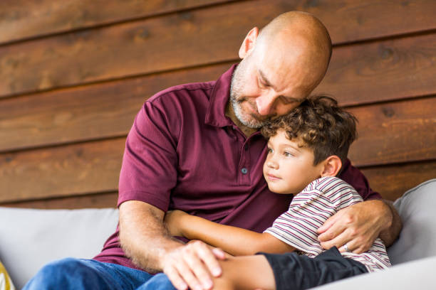 istock Hispanic father sitting and hugging his son. 1181131687