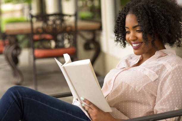 istock African American woman reading a book. 1181134105