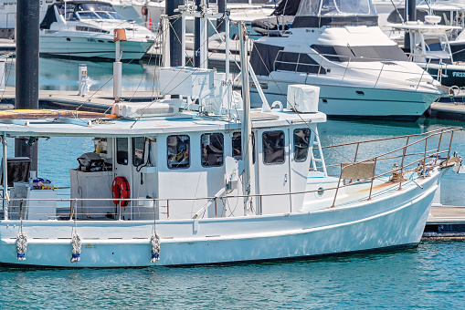 Mackay, Queensland, Australia - October 2019: A fishing boat moored at the marina on a calm sunny summer day