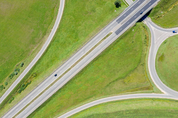 istock road intersection in green summer field background. aerial view 1181136320