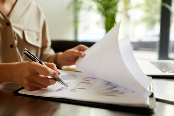 istock Woman working over financial reporting 1181137544