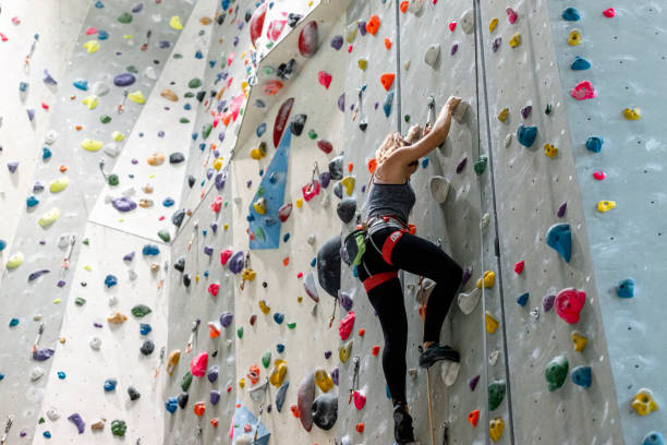 istock Woman climbing on climbing wall 1181141106