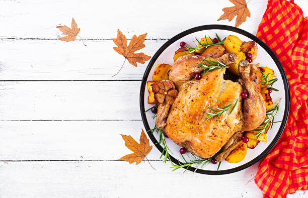 istock Roasted turkey garnished with cranberries on a rustic style table decorated  autumn leaf. Thanksgiving Day. Baked chicken. Top view 1181141203