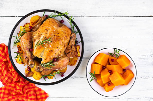 istock Roasted turkey garnished with cranberries on a rustic style table decorated  autumn leaf. Thanksgiving Day. Baked chicken. Top view 1181141204