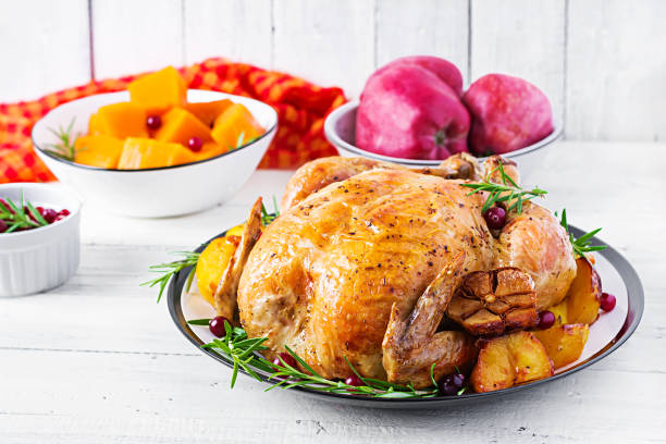 istock Roasted turkey garnished with cranberries on a rustic style table decorated  autumn leaf. Thanksgiving Day. Baked chicken. 1181141211