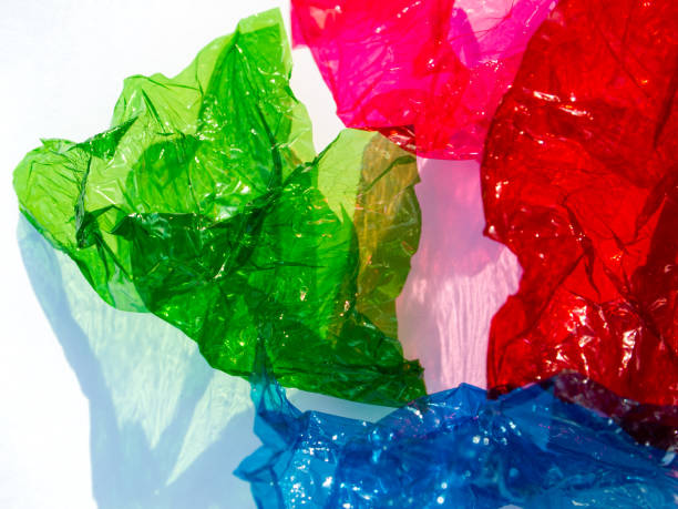 istock Thin sheet of multi coloured cellophane with shiny crumpled surface texture on white background, Abstract, Light & Shadow concept 1181141220