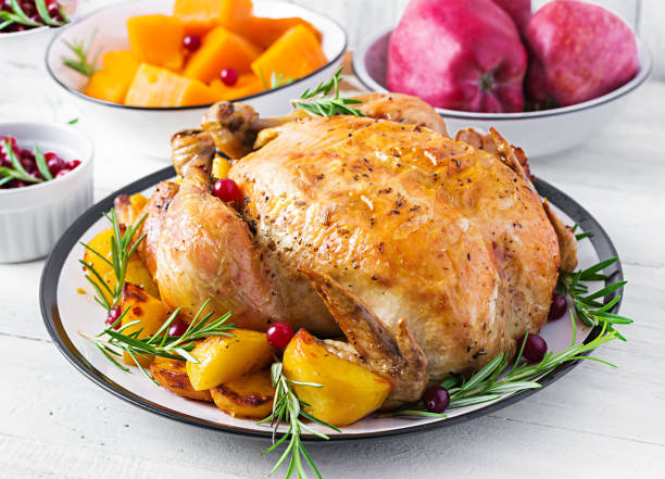 istock Roasted turkey garnished with cranberries on a rustic style table decorated  autumn leaf. Thanksgiving Day. Baked chicken. 1181141221