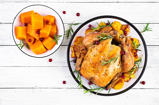 istock Roasted turkey garnished with cranberries on a rustic style table decorated  autumn leaf. Thanksgiving Day. Baked chicken. Top view 1181141224