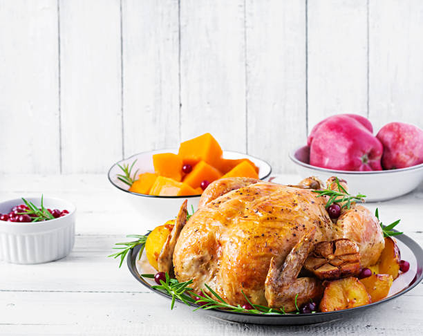 istock Roasted turkey garnished with cranberries on a rustic style table decorated  autumn leaf. Thanksgiving Day. Baked chicken. 1181141231