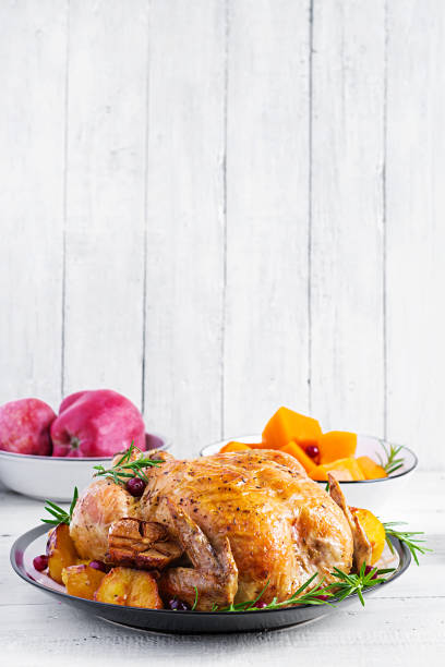 istock Roasted turkey garnished with cranberries on a rustic style table decorated  autumn leaf. Thanksgiving Day. Baked chicken. 1181141247