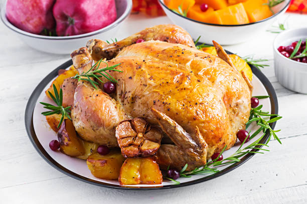 istock Roasted turkey garnished with cranberries on a rustic style table decorated  autumn leaf. Thanksgiving Day. Baked chicken. 1181141379