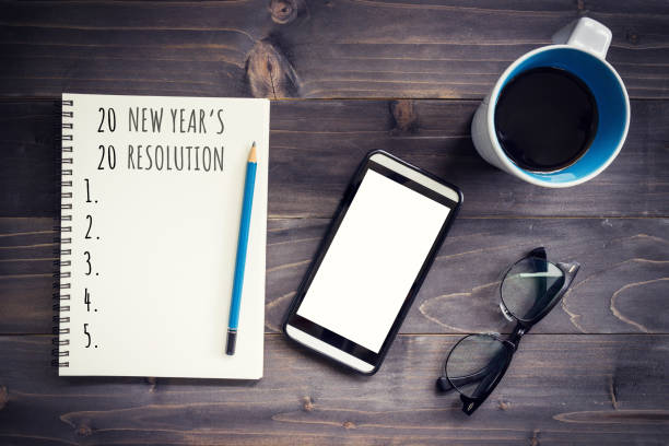 istock New Year goals, resolution or action plan 2020 concept. Office wood table with blank notepad, pencil, glasses, phone and cup of coffee. 1181144582