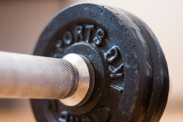 istock Bodybuilding concept: Barbell and weights on a gym floor 1181146056