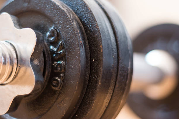 istock Bodybuilding concept: Barbell and weights on a gym floor 1181146057
