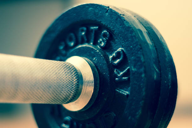 istock Bodybuilding concept: Barbell and weights on a gym floor 1181146272