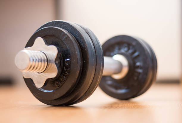 istock Bodybuilding concept: Barbell and weights on a gym floor 1181146302