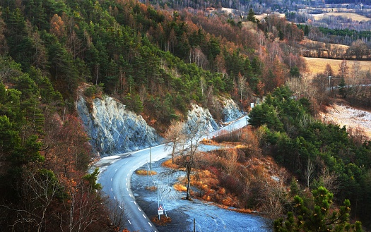 A view of an asphalt mountain road in the french alps. Ecrins massif