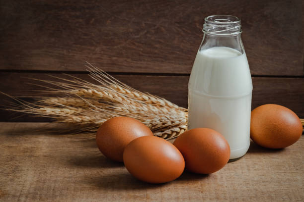 istock Milk bottle and eggs on wooden table 1181147092