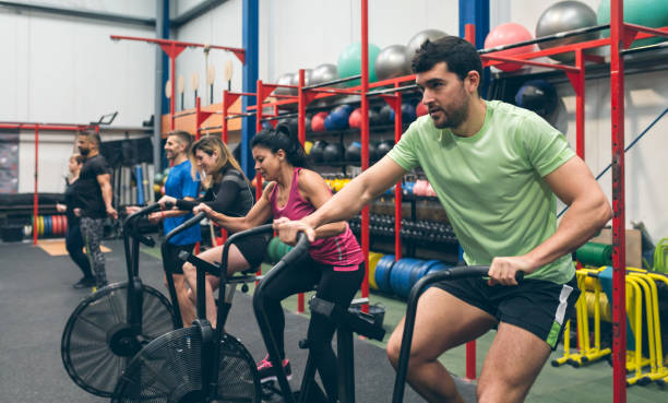 istock Athletes doing air bike indoor 1181147235