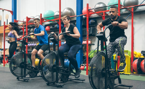 istock Athletes doing air bike indoor 1181147272