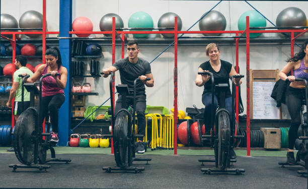istock Athletes doing air bike indoor 1181147286