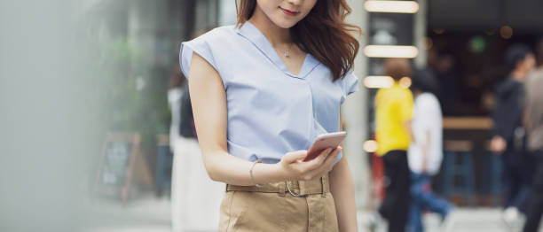 istock Young woman operating a smartphone 1181148309