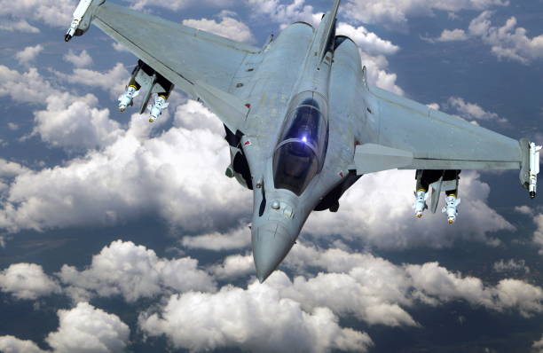 istock Military jet fighter flying above clouds 1181149792