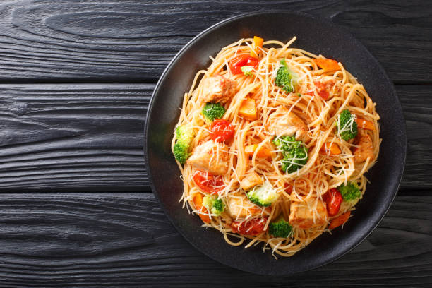 tasty pasta with chicken and vegetables close-up on a plate. horizontal top view - portion pumpkin vegetable black imagens e fotografias de stock